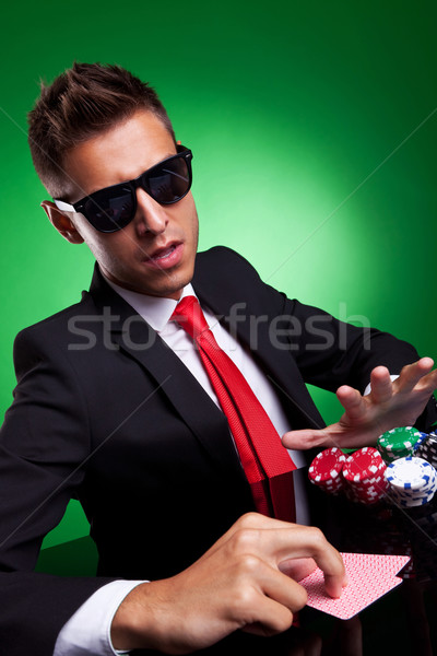 Confident young business man going all in Stock photo © feedough