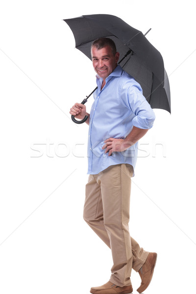 Stock photo: casual middle aged man under umbrella