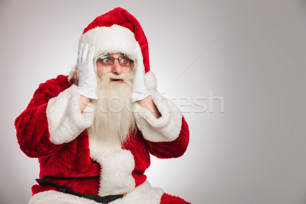 surprised santa claus looks to side Stock photo © feedough