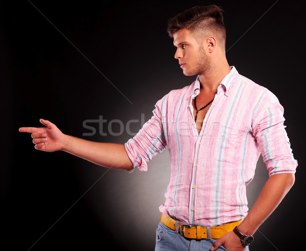 Stock photo: pointing to side & hand in pocket