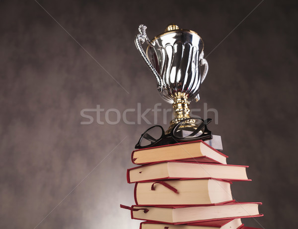 trophy cup award and glasses on top of  books Stock photo © feedough