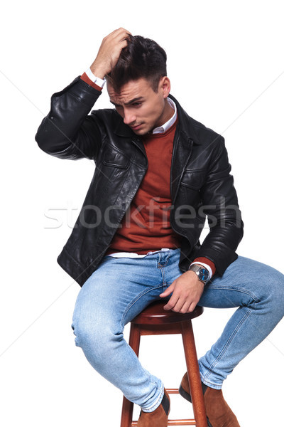 seated casual man passing hand through his hair looking sad  Stock photo © feedough