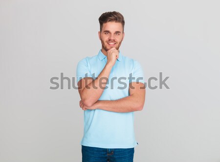 Souriant jeune homme bleu clair tshirt pense Photo stock © feedough