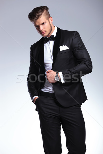 Stock photo: business man looks away with hand on jacket