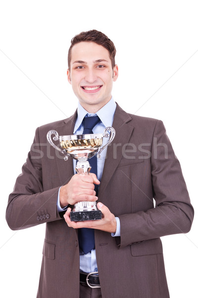 winning businessman holding his award Stock photo © feedough