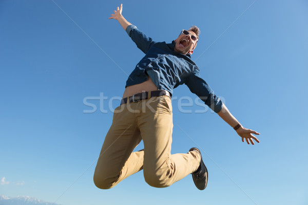 casual man jumps in mid-air Stock photo © feedough