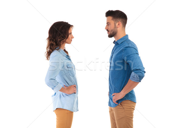 serious casual couple with hands on waist facing each other Stock photo © feedough