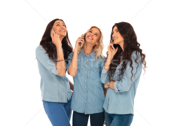 3 casual woman talking on the phone and looking up Stock photo © feedough