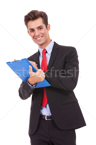 Homme d'affaires souriant écrit presse-papiers blanche affaires [[stock_photo]] © feedough