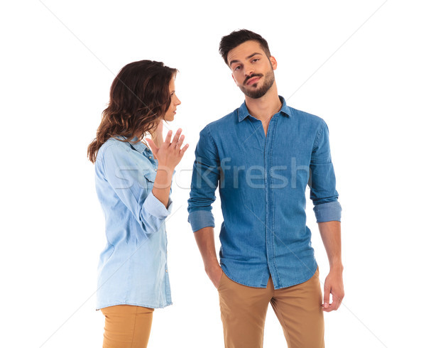Stock photo: bored casual man listening to his woman talk at him