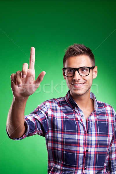 a casual young man pressing a button Stock photo © feedough