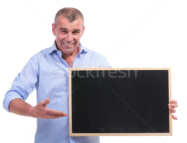 casual middle aged man points at blackboard Stock photo © feedough