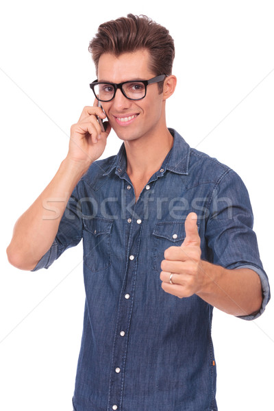 Stock photo: man on the phone shows thumb up
