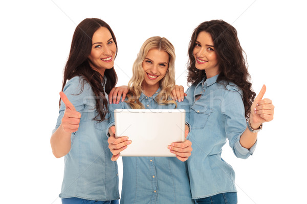 3 women reading good news on a tablet pad computer Stock photo © feedough