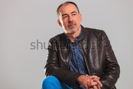 Stock photo: smiling mature man in leather jacket resting 