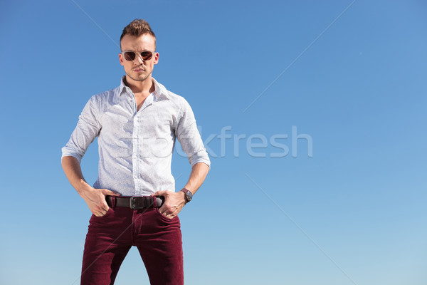 casual man with hands in pocket in front of blue sky Stock photo © feedough