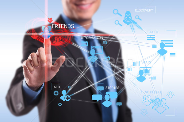 Stock photo: business man pushing the friends button 