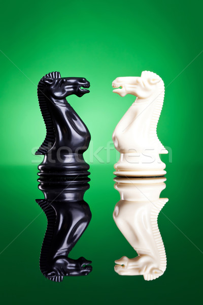 Stock photo: white and black knights facing aeach other