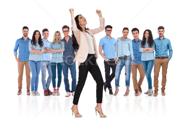 excited businesswoman celebrating while standing in front of her Stock photo © feedough