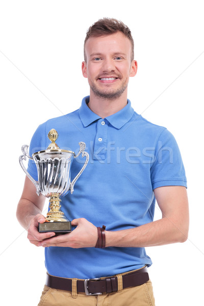 casual young man with trophy in hands Stock photo © feedough