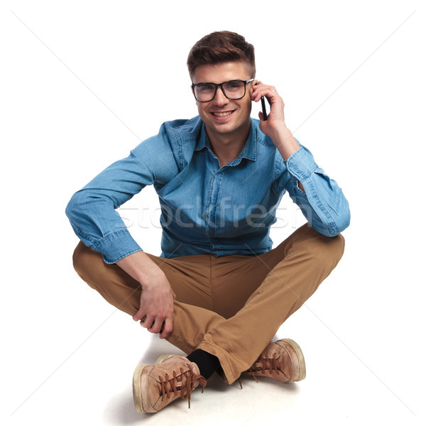 casual man sits  and talks on the phone  Stock photo © feedough