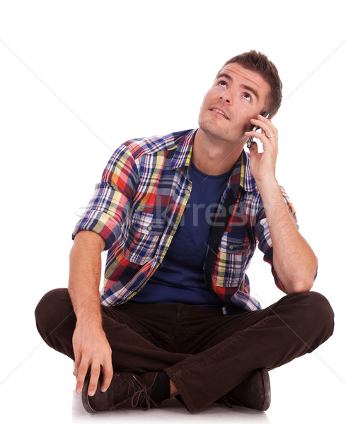 Joven teléfono sentado hasta casual Foto stock © feedough