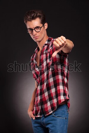 handsome young man with thumbs down Stock photo © feedough