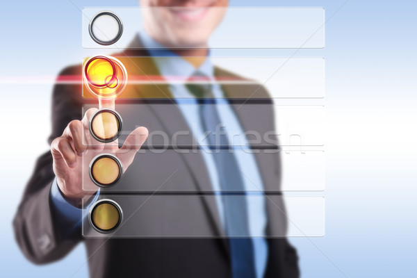 Souriant homme d'affaires poussant bouton liste [[stock_photo]] © feedough