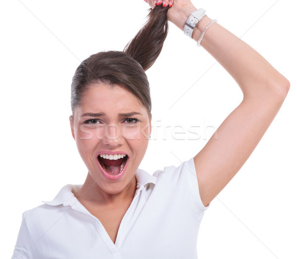 casual woman pulling hair & yelling Stock photo © feedough
