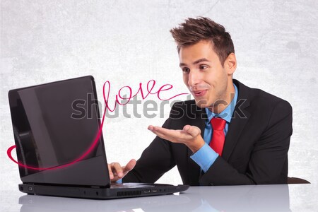 young business man cheers while reading on laptop Stock photo © feedough