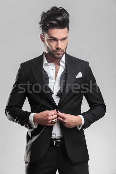 young man wearing tuxedo closing his jacket Stock photo © feedough