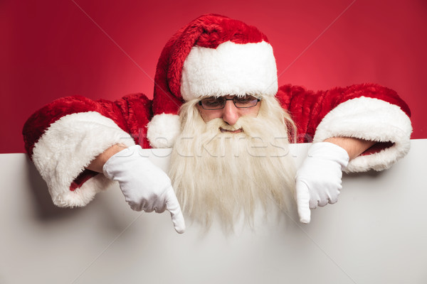 santa claus is pointing down to blank billboard Stock photo © feedough