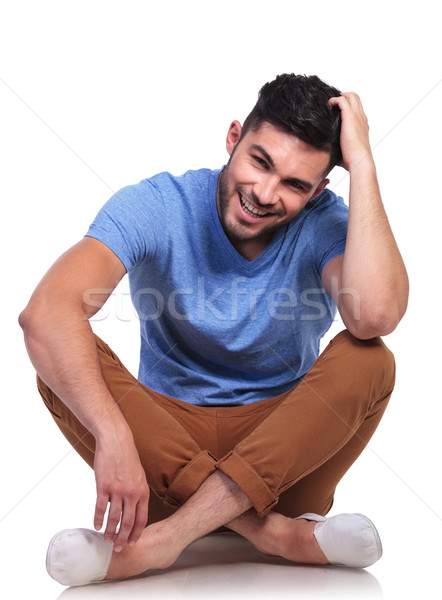 seated casual man passing his hand through his hair Stock photo © feedough