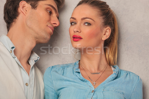 woman posing in studio background while boyfriend is looking at  Stock photo © feedough