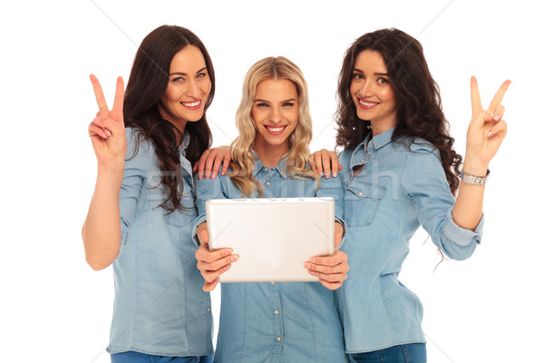 three casual women with a tablet making victory sign Stock photo © feedough