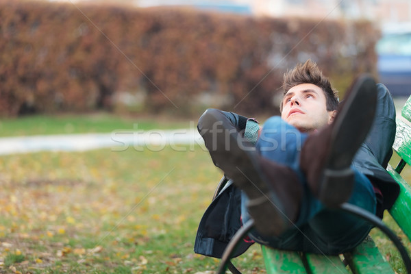 relaxed man on a bench in a park Stock photo © feedough