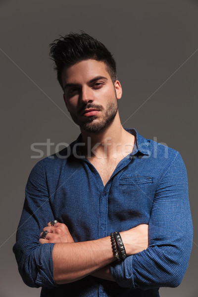 confident fashion man standing with hands crossed and smiles Stock photo © feedough