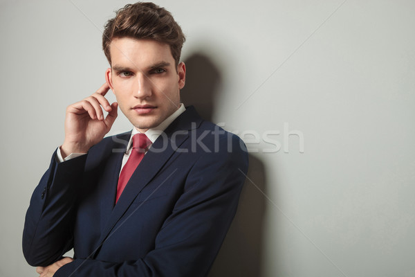 young business man touching his right ear Stock photo © feedough