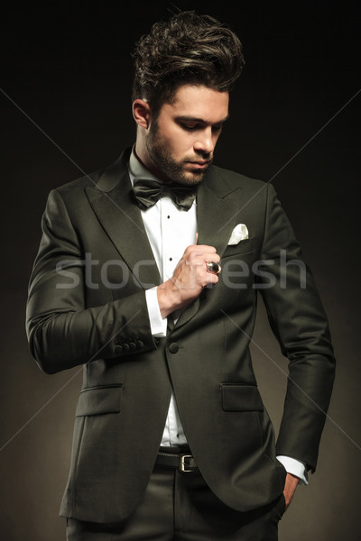 Stock photo: Handsome business man fixing his tuxedo