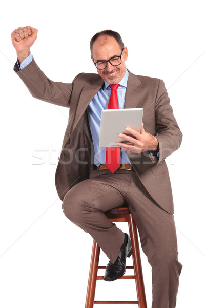 old businessman reading good news on tablet Stock photo © feedough