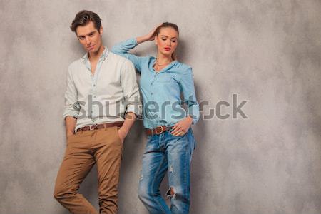 Stock photo: woman looking down while her boyfriend poses