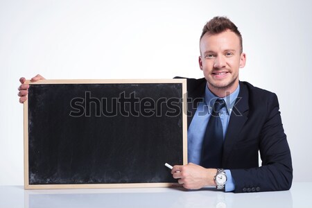 business man holds a blackboard and shows ok Stock photo © feedough