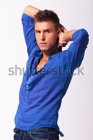 casual man adjusts his hair and looks away Stock photo © feedough