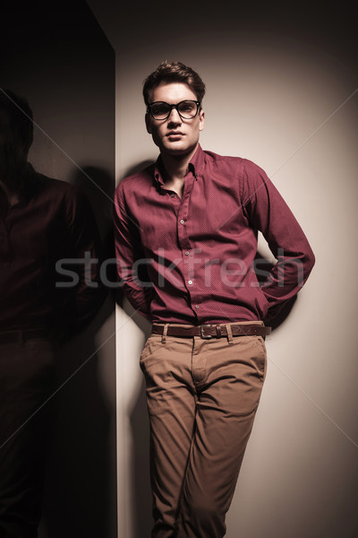 Young casual business man leaning on a  grey wall  Stock photo © feedough