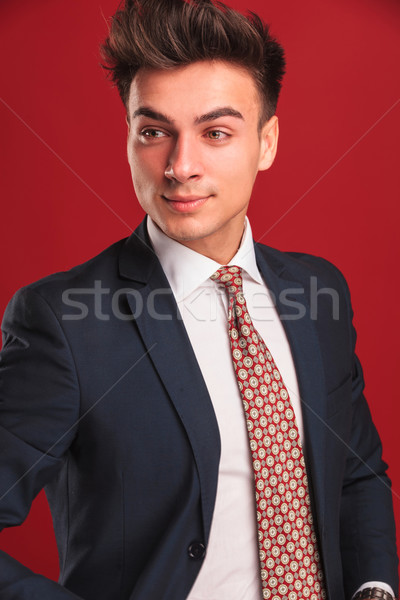 portrait of businessman in black suit on red background Stock photo © feedough