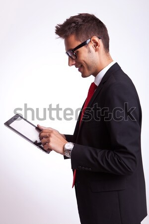 portrait of smiling stylish man holding glasses while sitting Stock photo © feedough