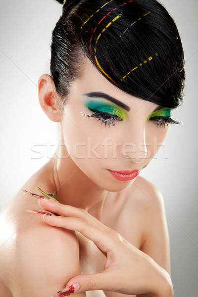 Front view of a model with multicolored make-up and nails Stock photo © feedough