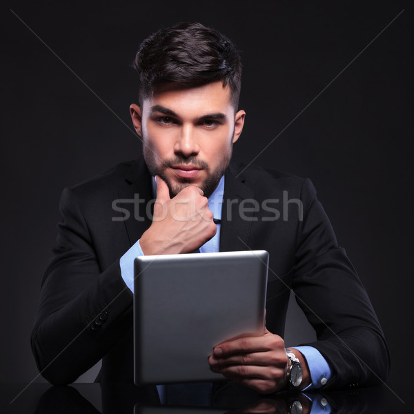 pensive young business man with tablet Stock photo © feedough