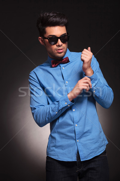serious fashion man fixing his shirt Stock photo © feedough