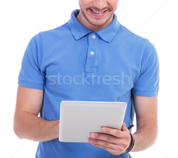 casual young man works on tablet Stock photo © feedough